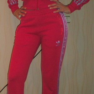 Adidas womans red suit with white stripes hips front pose shot