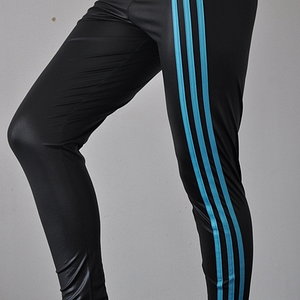 Adidas womans tight shiny black pants with blue stripes front