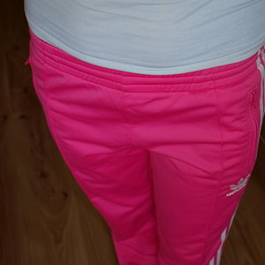 Adidas womans pink pants with white stripe grey top high angle shot front