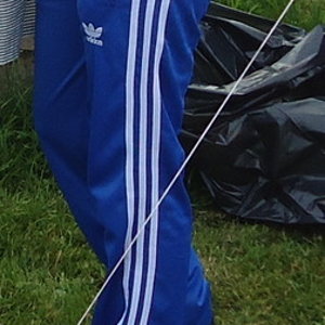 Adidas womans dark blue pants with white stripes side angle shot