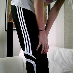 Adidas womens black pants hand knee leaning pose