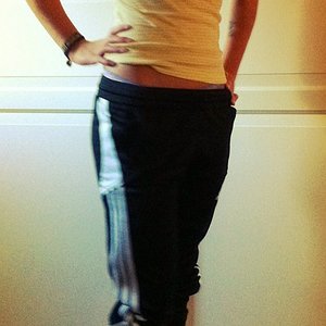 Adidas womens black pants with white stripe close hip shot