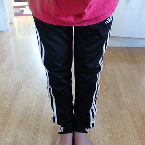 Adidas womens black pants light red top front high angle