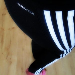 Adidas womens black pants white stripe high angle close up pink sneaker