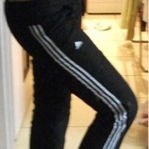 Adidas womens black pants white wtripe knee raise pose