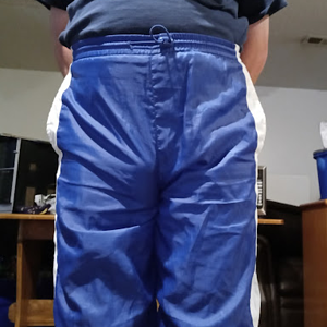 Me with my hands behind my back in my blue shirt & my small blue GTM Sportswear Nylon Pants 1.png