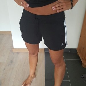 Girl in black/white Adidas shorts