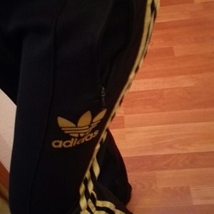 Girl in Adidas black pants