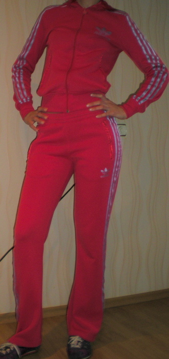 Adidas womans red suit with white stripes hips front pose shot