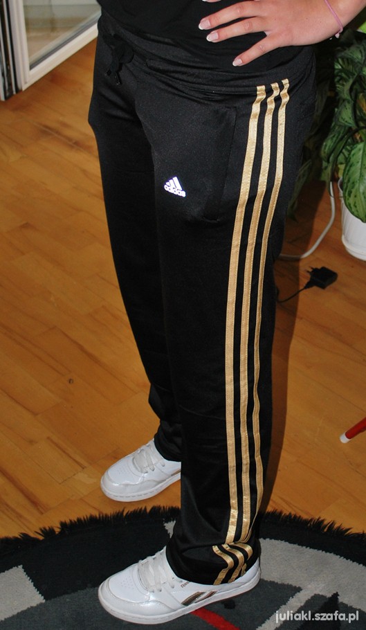 Black adidas hotsell with gold stripes