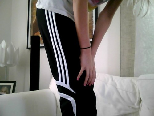 Adidas womens black pants hand knee leaning pose