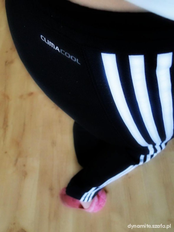 Adidas womens black pants white stripe high angle close up pink sneaker