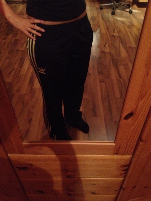 Girl in black/white Adidas pants