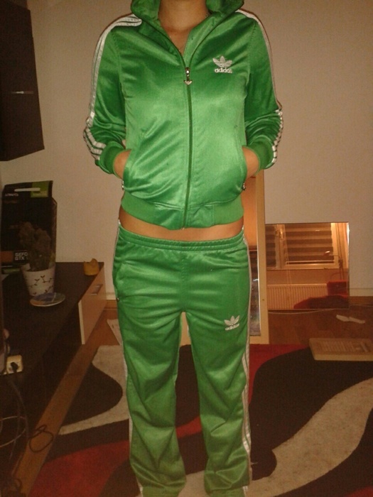 Girl in shiny green Adidas outfit