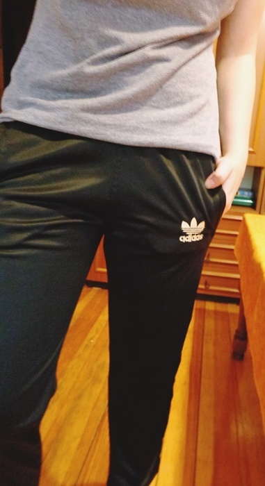 Girl with shiny black adidas pants