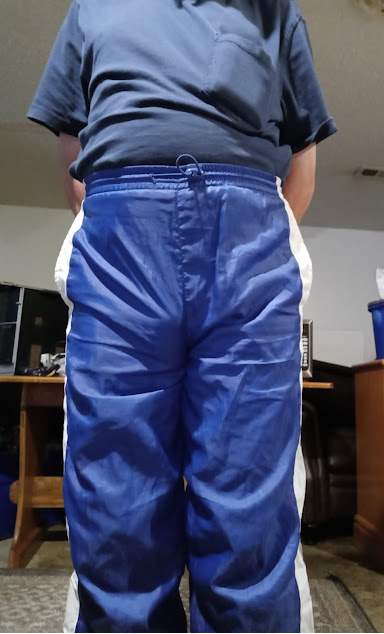 Me with my hands behind my back in my blue shirt & my small blue GTM Sportswear Nylon Pants 1.png